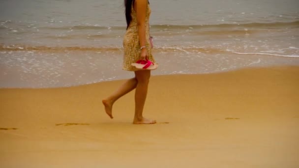 Woman walking along the ocean — Stockvideo