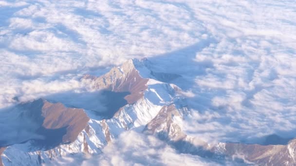 Flying in the clouds over the mountain ranges