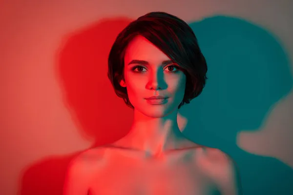 Photo of charming calm peaceful lovely bob hairdo woman look camera isolated red neon light color background — Stock Photo, Image