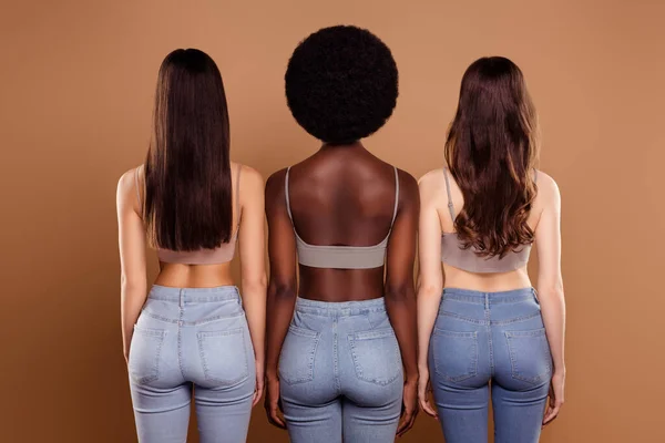 Photo of sexy slim three best friends wear cropped tops standing backs isolated beige color background — Stock Photo, Image