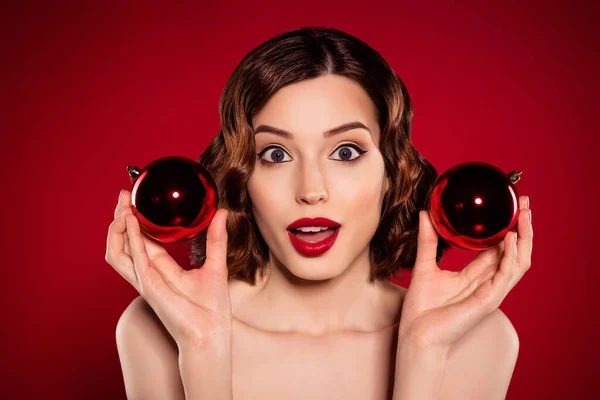 Photo of astonished funky model lady tender woman hold christmas decoration isolated on gradient red color background — Stock Photo, Image