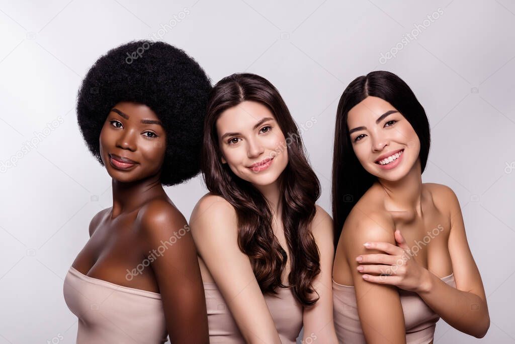 Photo three young attractive girls happy positive smile bodycare cosmetology perfection isolated grey color background