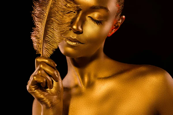 Close up photo of gorgeous lady statue metal sparkles body feather cover her closed eye isolated dark color background — Foto de Stock