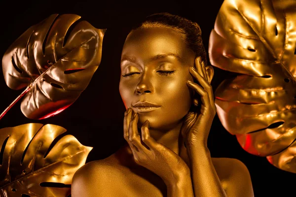 Altın kaplamalı göz kamaştırıcı heykelin portresi. Çiçekli, karanlık ormandaki memnuniyetten gözlerini kapat.