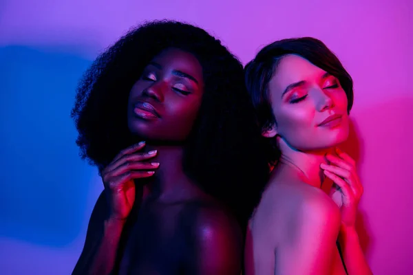 Portrait of two attractive naked dreamy women touch perfect smooth skin isolated bright neon purple color background — Stock Photo, Image