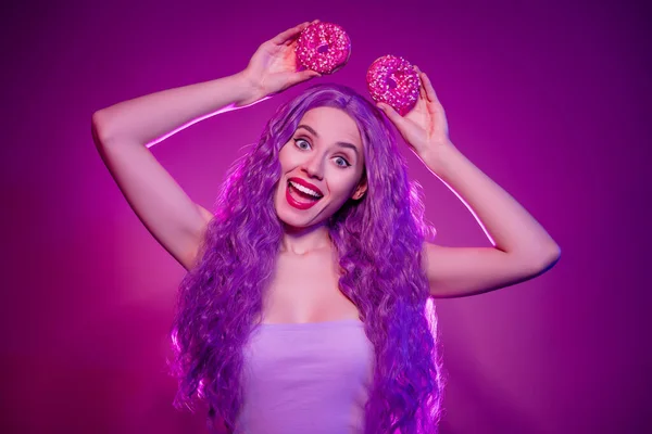 Photo of stunning minni mouse role play girly lady with long lilac purple wig curls hold two donuts like ears have fun.