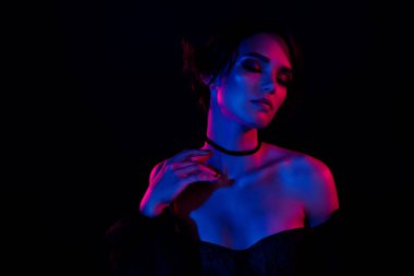 Photo of tender magic vamp lady enjoying masquerade touching her chest isolated on vivid vibrant color background.