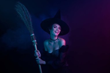 Photo of tempting magician lady enjoying night flight on broom stick isolated ultra violet dark color background.