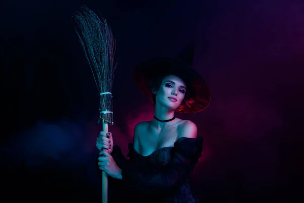 Photo of stunning magician lady holding flying broom stick night isolated on ultra colored background.