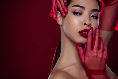 Close up photo of charming chic lady wearing red gloves look attractive empty space isolated burgundy color background.