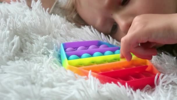 Kid Playing Pop Sensory Toy Girl Pressing Colorful Rainbow Squishy — Stock Video