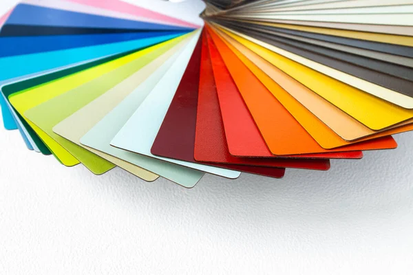 Color guide displaying a range of hues for use in interior design and decoration. Colorful color guide with palette of paint samples on white background with copy space. Catalog for tinting