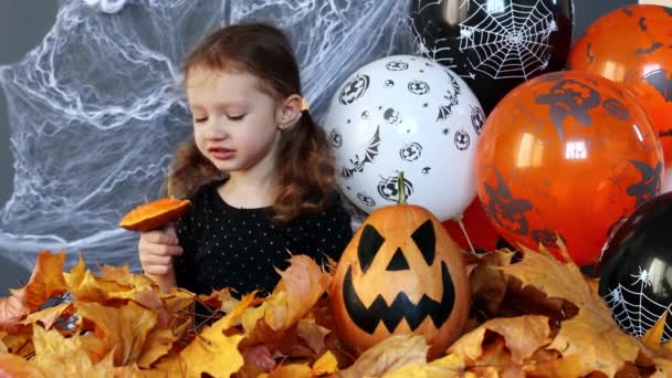 Little Witch Girl Funny Eating Slice Pumpkin Background Halloween Attributes — 图库视频影像