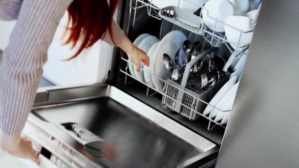 Young Woman Opens Dishwasher Door Takes Out Clean White Utensils — Stockvideo