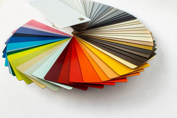 Color guide displaying a range of hues for use in interior design and decoration. Colorful color guide with palette of paint samples on white background with copy space. Catalog for tinting.