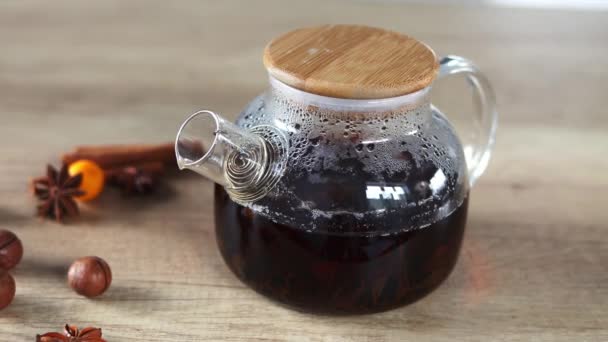 Fragrant Black Tea Brewed Glass Teapot Wooden Background Decorated Nuts — 图库视频影像