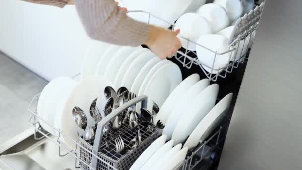 Young Woman Closes Dishwasher White Dishes Build Kitchen Modern Home — 图库视频影像