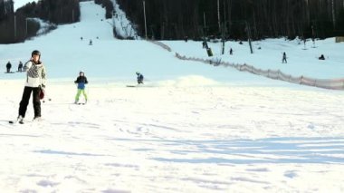 People ski on the snow slope in slow motion in the winter ski resort . Ski elevator on snow mountain. Winter activity. The concept of rest, hobbies, health.