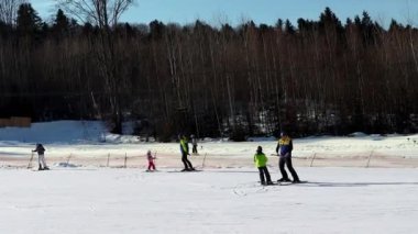 The instructor teaches a little girl to ski in the winter ski resort. Ski elevator on snow mountain. Winter activity. The concept of rest, hobbies, health.