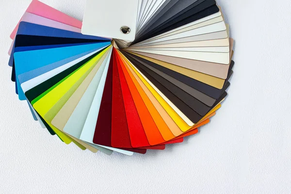 Color guide displaying a range of hues for use in interior design and decoration. Colorful color guide with palette of paint samples on white background with copy space. Catalog for tinting.