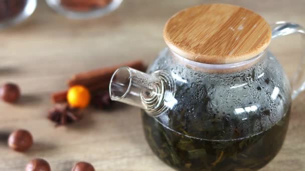 Fragrant Green Tea Brewed Glass Teapot Wooden Background Decorated Nuts — Vídeos de Stock