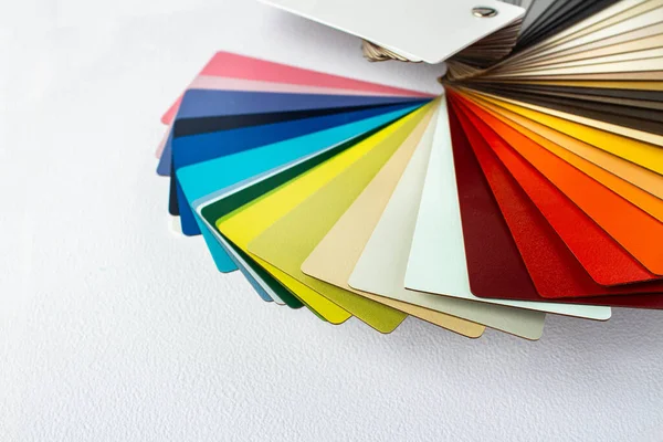 Color guide displaying a range of hues for use in interior design and decoration. Colorful color guide with palette of paint samples on white background with copy space. Catalog for tinting.