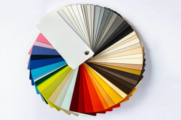 Color guide displaying a range of hues for use in interior design and decoration. Colorful color guide with palette of paint samples on white background with copy space. Catalog for tinting.