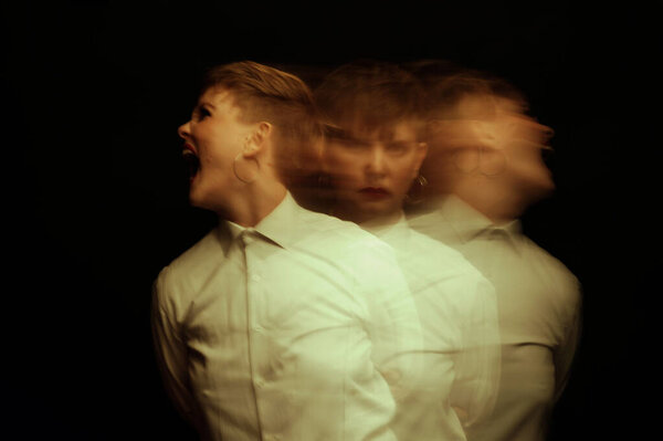 crazy psychopathic girl with mental disorders in straitjacket