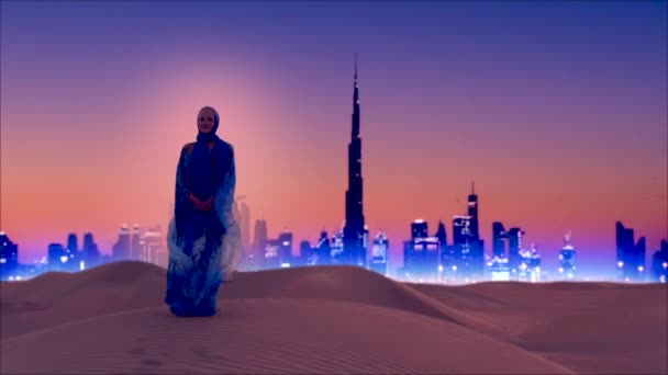 Woman wears in traditional arab dress stands in the desert with Dubai city lights on the background — Stockvideo