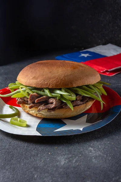 Chilean Latin american sandwich burger Chacarero with premium beef slices and green bean on black background