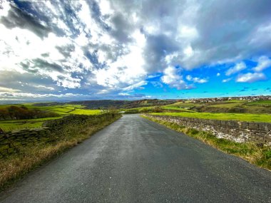 Yağmur bulutları, Jackson Hill yolunda ilerliyor, arazileri ve tepeleri olan, Bradford, Yorkshire, İngiltere yakınlarındaki