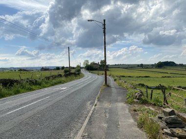 Allerton main road toward Denholme, with fields and houses in the distance in, Allerton, Bradford, UK 