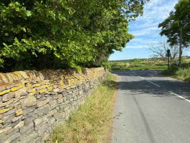New Lane country road junction, with dry stone wall and old trees near, Tong, Bradford, Yorkshire, UK
