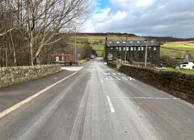 Aşağıya bak, Billy Lane bir kış günü, kuru taş duvarlar, eski binalar ve yakınlardaki kulübelerle, Hebden Köprüsü, İngiltere