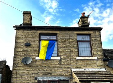 Ukraine flag, hanging from a house window on, New Hey Road, Brighouse, UK clipart