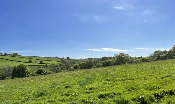 Rural landscape, with fields, trees, and buildings near the horizon, on the hills near, Cononley Keighley, UK