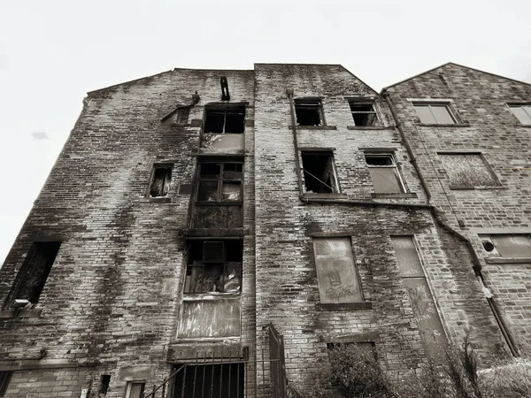 Large derelict, Victorian stone built mill on, Westend Street, in the post industrial city of, Bradford, UK     black and white