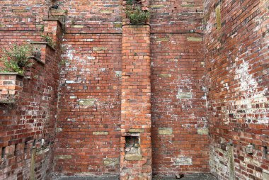 Victorian red brick walls, belonging to a partially demolished building in, the post industrial city of, Bradford, Yorkshire, UK