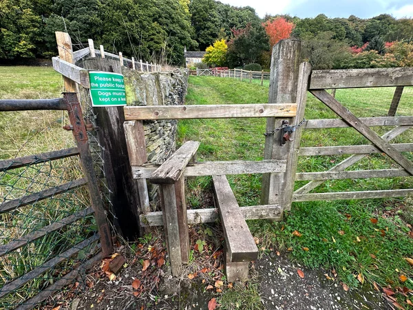 Old walkers stile, with a path, leading through the fields, and into the woods on, Wood Bottom Lane, Brighouse, UK