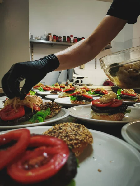The process of making hamburgers with homemade buns and cutlets