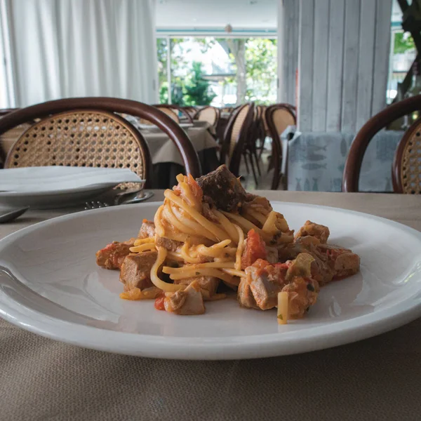 Italian pasta with spicy tomato and tuna sauce