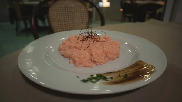 Risotto with beetroot juice on a decorated plate