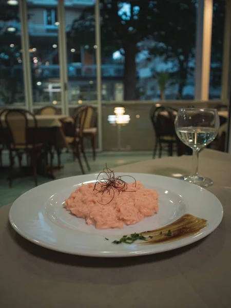 Risotto with beetroot juice on a decorated plate
