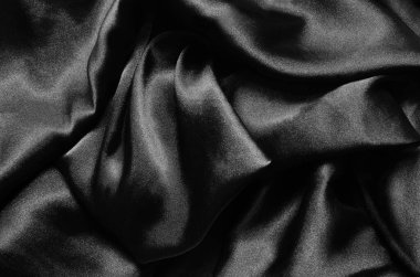 Siyah parlak saten kumaş arka plan, yakın plan..