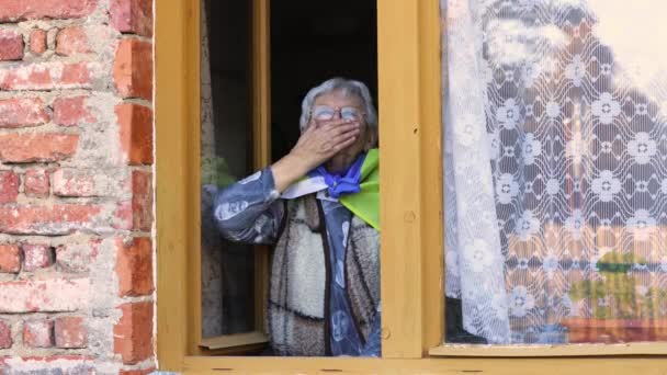 Ukrainska mormor med flagga med rädsla lidande och be fred under krig konflikt mellan Ryssland och Ukraina, invasion av Ryssland i Ukraina, ära till Ukraina — Stockvideo