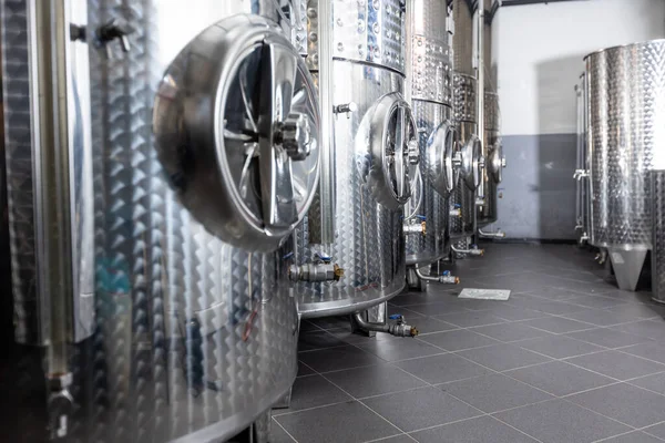 Close up of a wine factory with small steel tanks for storage and fermentation of arrenge of a wine, alcohol drink concept — Foto Stock