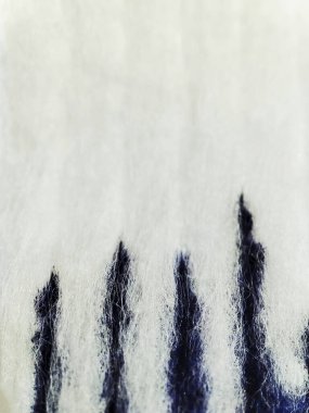 macro texture of white fabric with dark blue paint