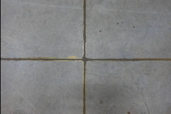 公共空間にある大きな灰色のコンクリートの床の詳細 十字の形をした縫い目があり フレームは4つの長方形に分かれています テクスチャ — ストック写真