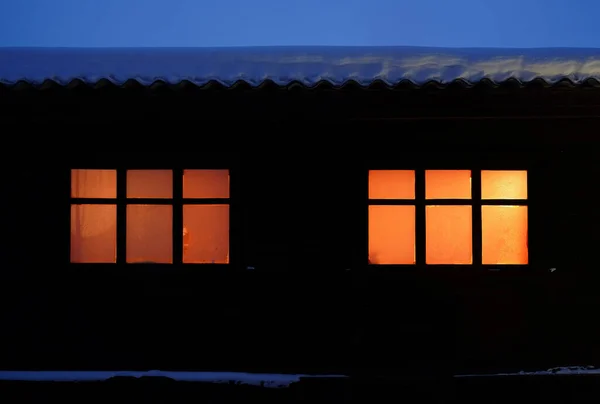 Dark Wall Rural Wooden House Dusk Two Windows Lit Windows — Stockfoto