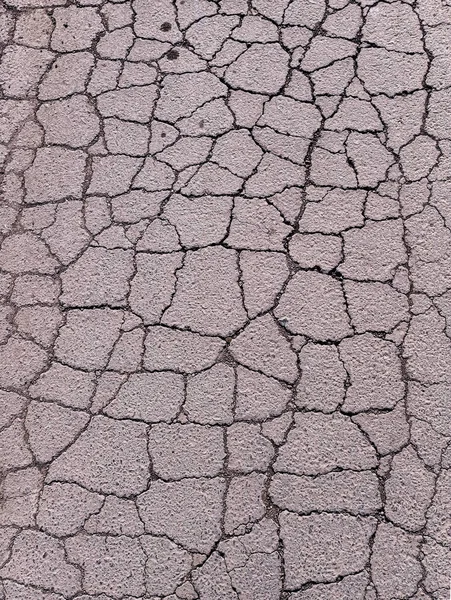 Old road background - surface of gray cracked asphalt close up — Stock Photo, Image